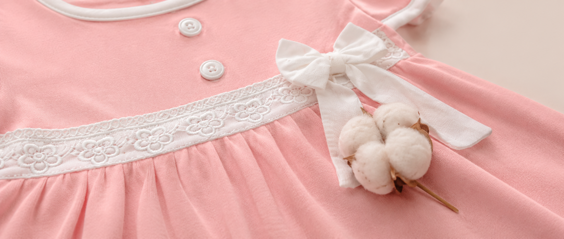 Premium BabyRon Princess baby dress with intricate lace details and a cotton boll on soft fabric, highlighting fabric quality in an organic cotton baby clothes guide