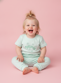 Misty Green — BabyRon Optimist premium organic cotton baby pyjama set worn by baby girl model, soft breathable baby wear for 0–12 months, gentle on sensitive skin, premium baby clothing India by BabyRon