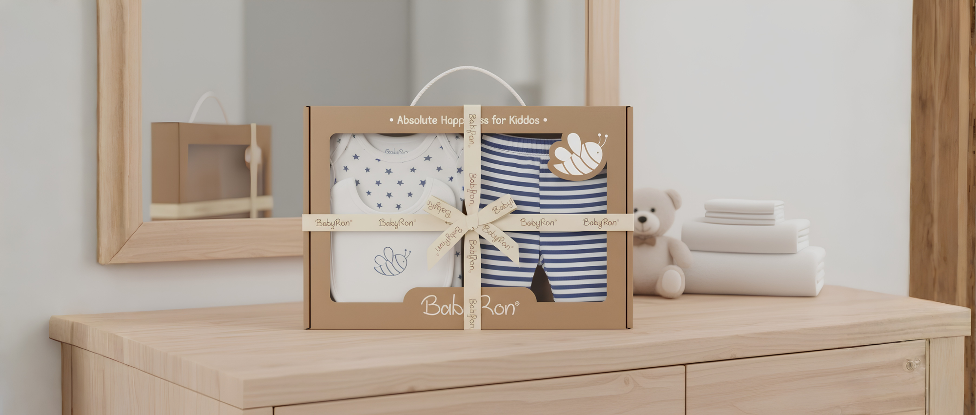 BabyRon newborn essentials gift set featuring organic cotton baby rompers and striped bodysuits in eco-friendly kraft packaging. GOTS certified baby clothes India for happy kiddos.